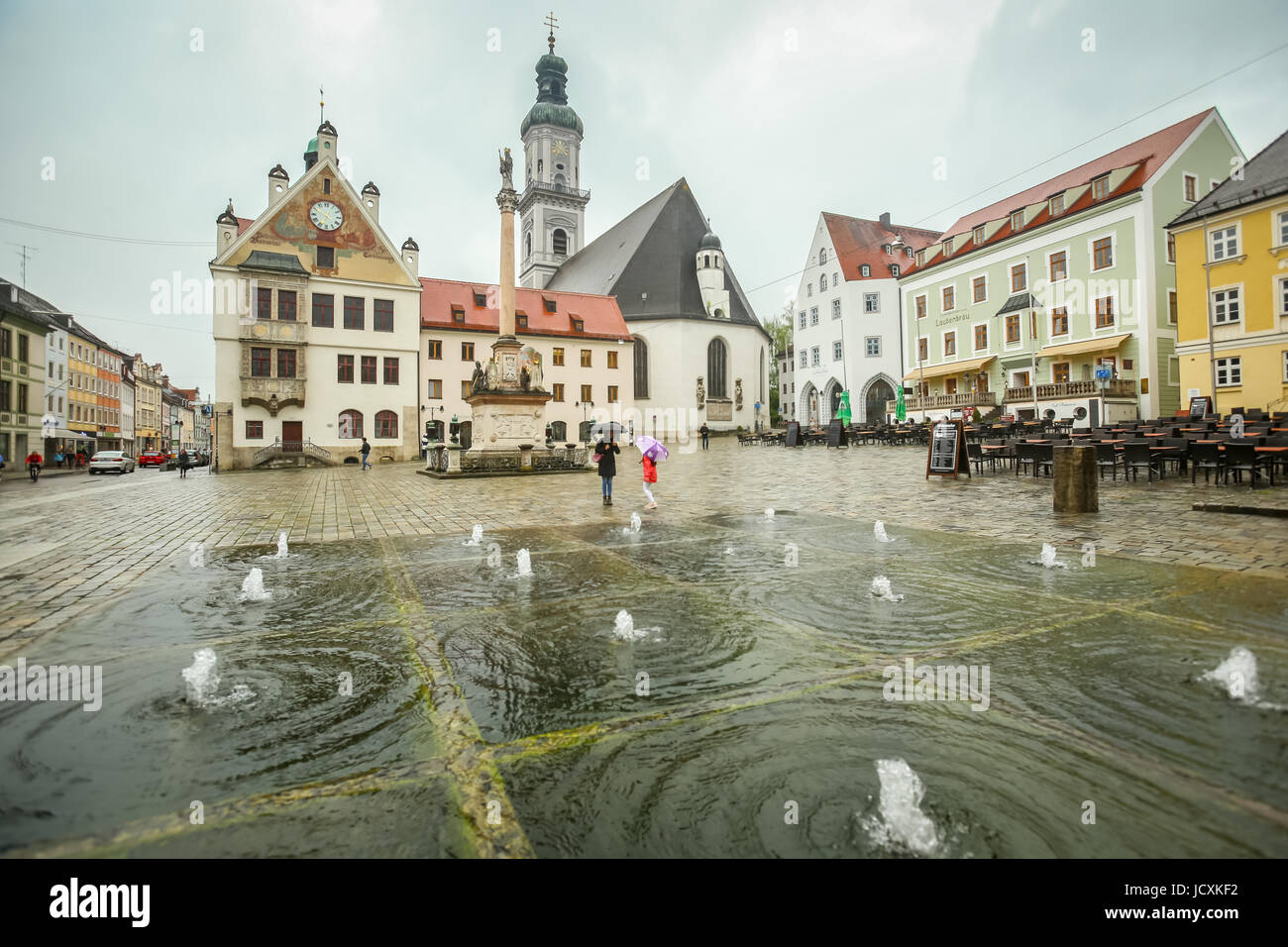 FREISING, Germania - 8 Maggio 2017 : le persone camminare al fianco di fontane ad acqua presso la piazza della città con il municipio e Saint Georges Chiesa di Frisinga, Germa Foto Stock