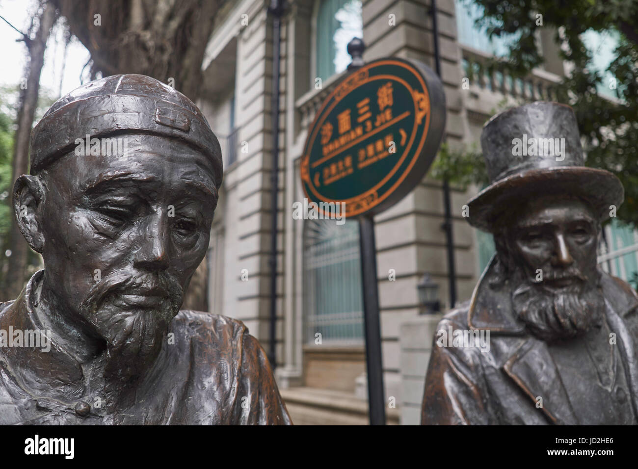 Sculture in bronzo della vecchia Cina coloniale e gli uomini europei vivono insieme all'aperto - Arte di strada sulla isola di Shamian, Guangzhou, Cina Foto Stock