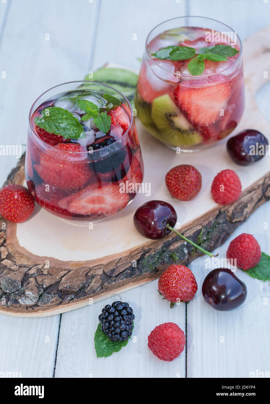 Bicchieri di acqua di frutta con vari ingredienti presentati su un disco ad albero Foto Stock