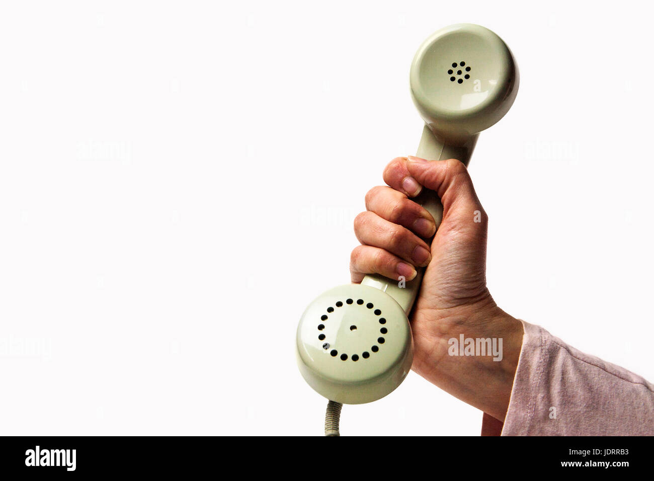 Mano che tiene una luce verde telefono retrò isolati su sfondo bianco Foto Stock