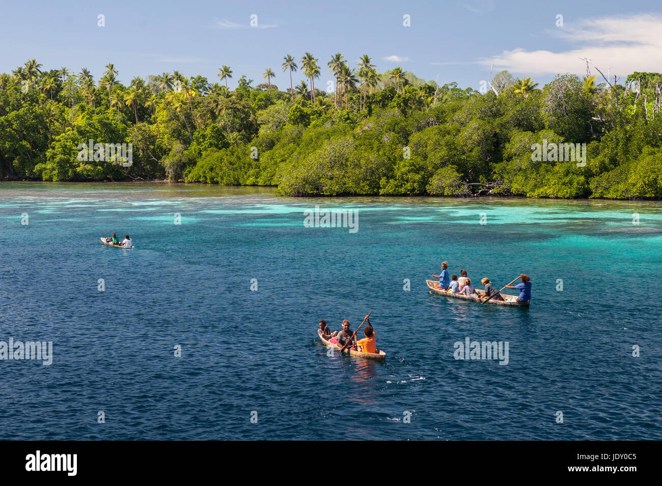 Natives paddling in canoa, Melanesia, Oceano Pacifico Isole Salomone Foto Stock