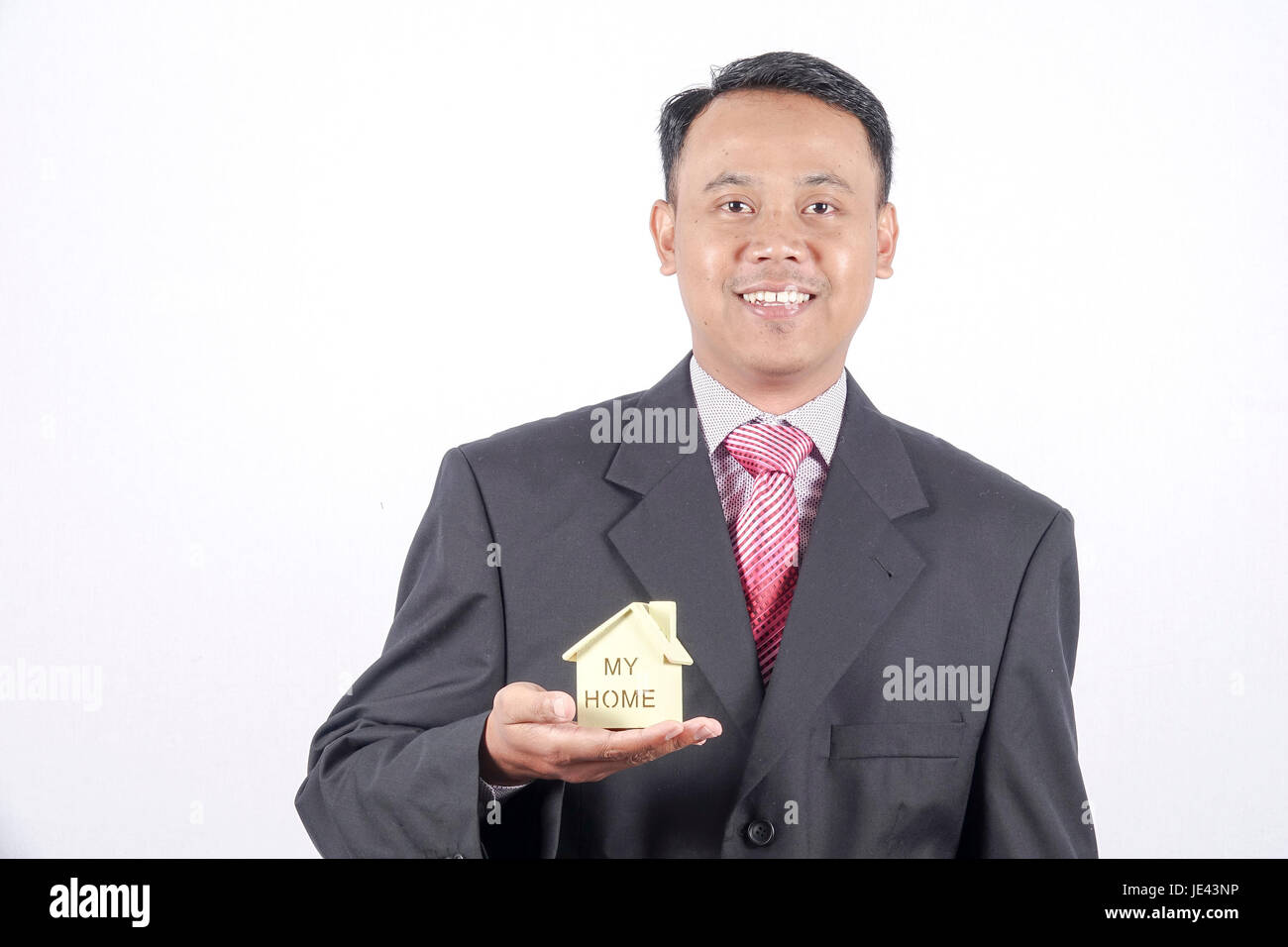 Giovane imprenditore tenendo un modello di casa Foto Stock