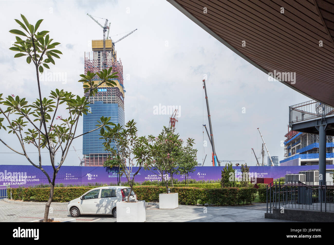 Gru operano al di sotto della costruzione della torre di firma in Tun Razak Exchange financial district, sviluppato da TRX City Sdn., a Kuala Lumpur in Malesia Foto Stock