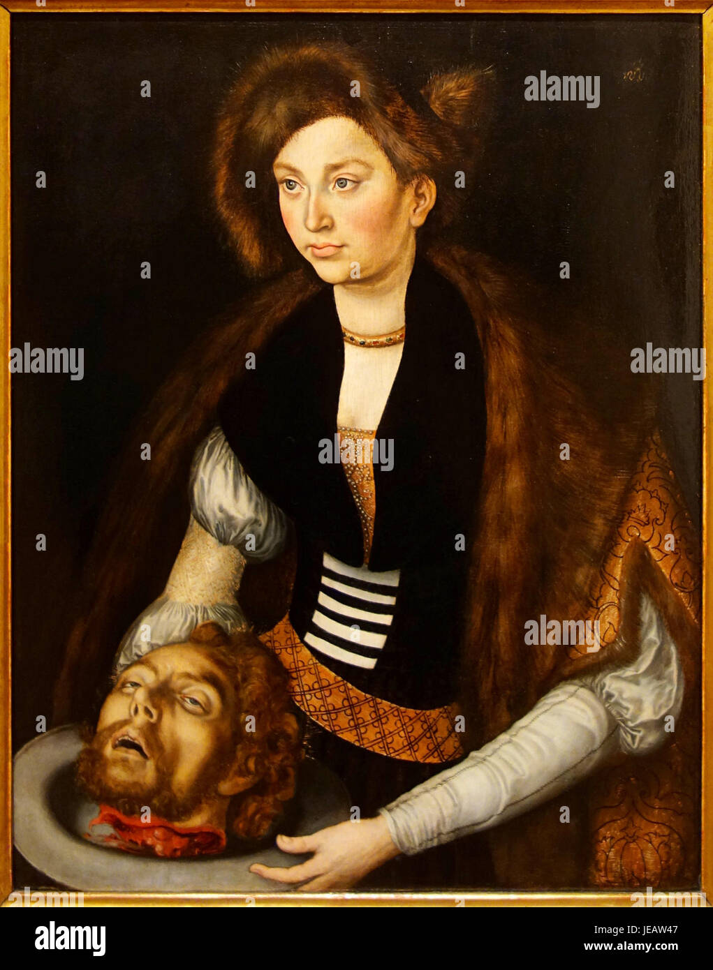 Il Salomè di Lucas Cranach il Vecchio è un dipinto ad olio che raffigura la storia biblica di Salomè con la testa di Giovanni Battista. Creato all'inizio del XVI secolo, mostra la dettagliata raffigurazione di figure bibliche di Cranach. Foto Stock