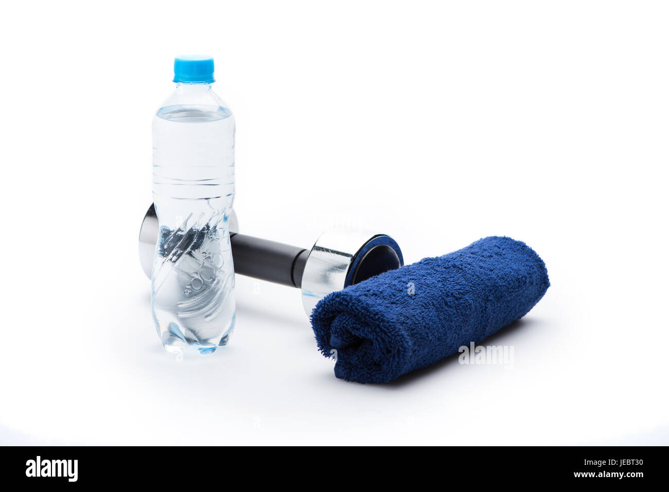 Manubrio metallico, asciugamano e una bottiglia con acqua isolato su bianco. Le attrezzature di sport e di uno stile di vita sano concetto Foto Stock