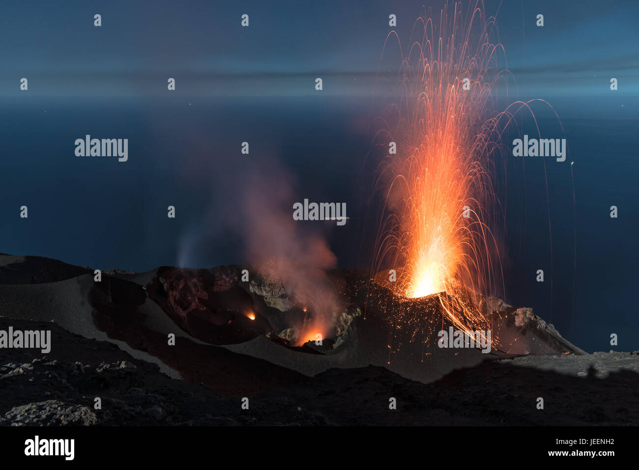 Stromboliane forte eruzione vulcanica dal vulcano di Stromboli (Isole Eolie Lipari, Italia) di notte, crateri illuminati dalla luna, Giugno 2017 Foto Stock