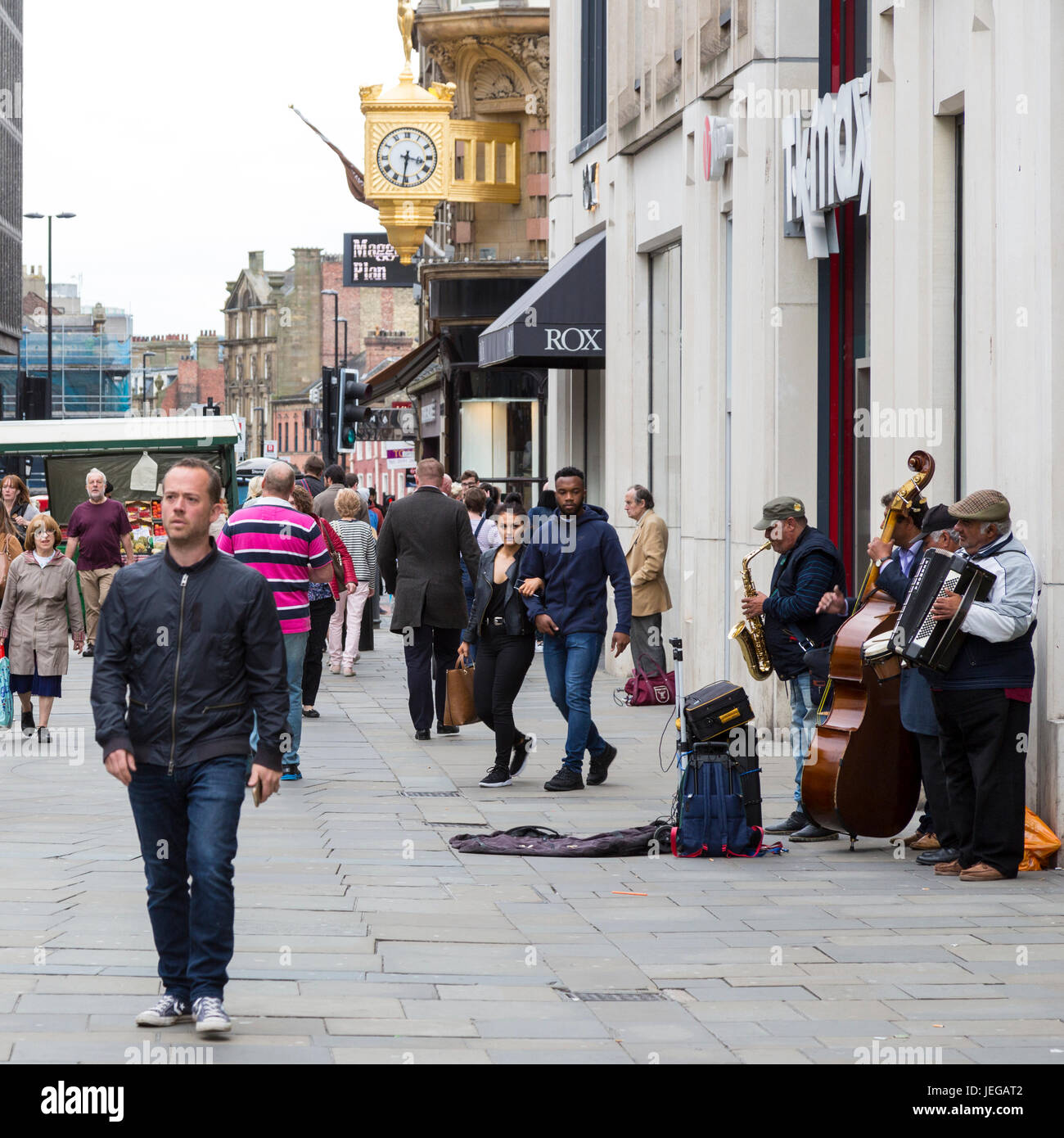 Newcastle-upon-Tyne, Inghilterra, Regno Unito. Northumberland Street scena con musicisti e pedoni. Foto Stock