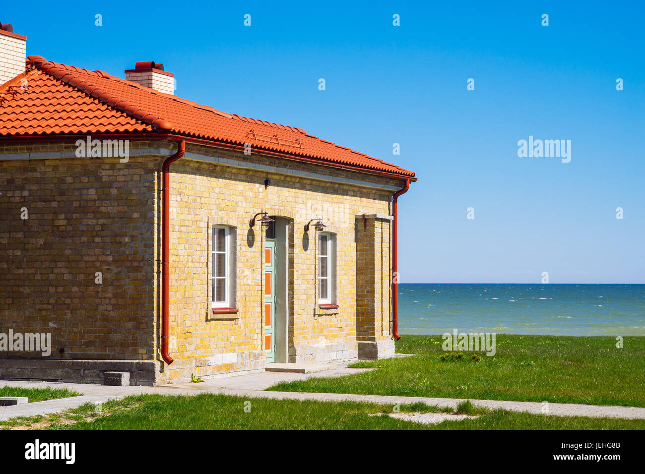 Mattoni casa al mare sulla giornata di sole contro il cielo blu Foto Stock