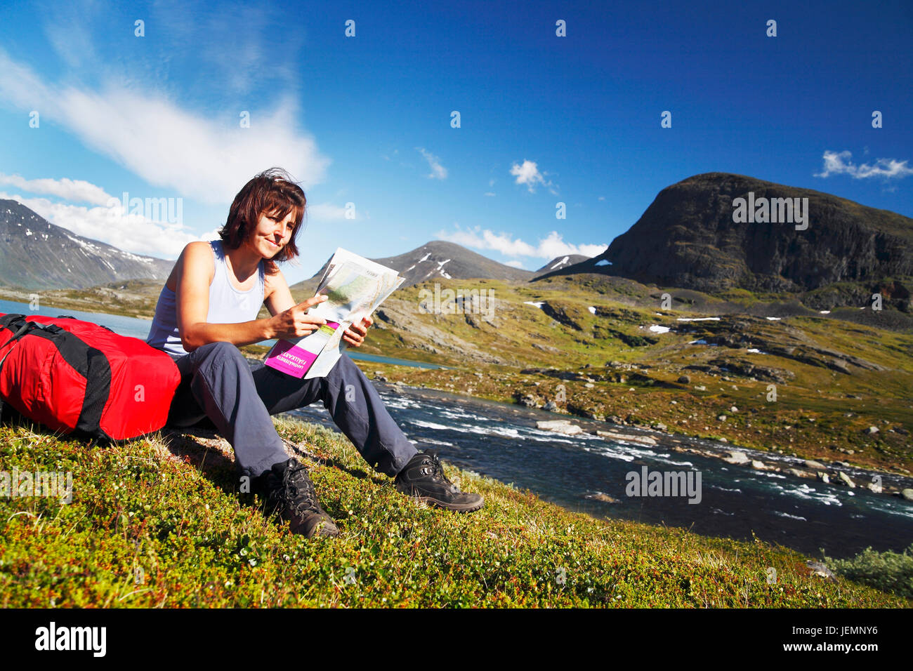 Donna mappa di lettura in montagna Foto Stock