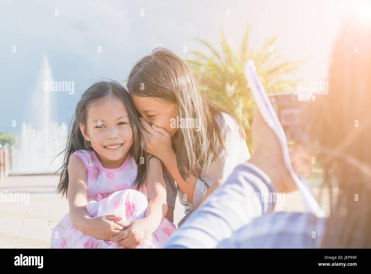 Madre e figlia di scattare una foto in giardino. Concetto di relazione di famiglia. Foto Stock