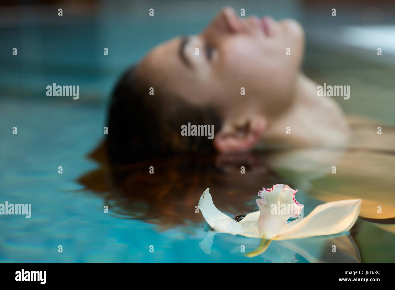 L'Europa, Italia, Helvetia Thermal Spa Hotel Porretta Terme, modello di nuoto in piscina termale con un flottante delle orchidee Foto Stock