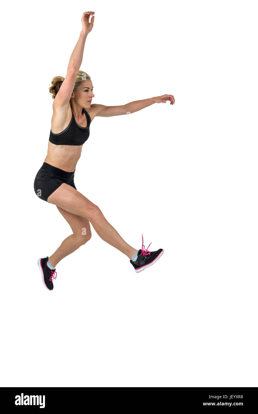 Athletic donna esercita su sfondo bianco Foto Stock