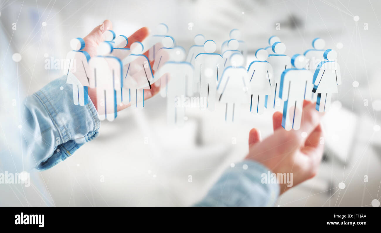 Imprenditore su sfondo sfocato tenendo il rendering 3D gruppo di persone nella sua mano Foto Stock