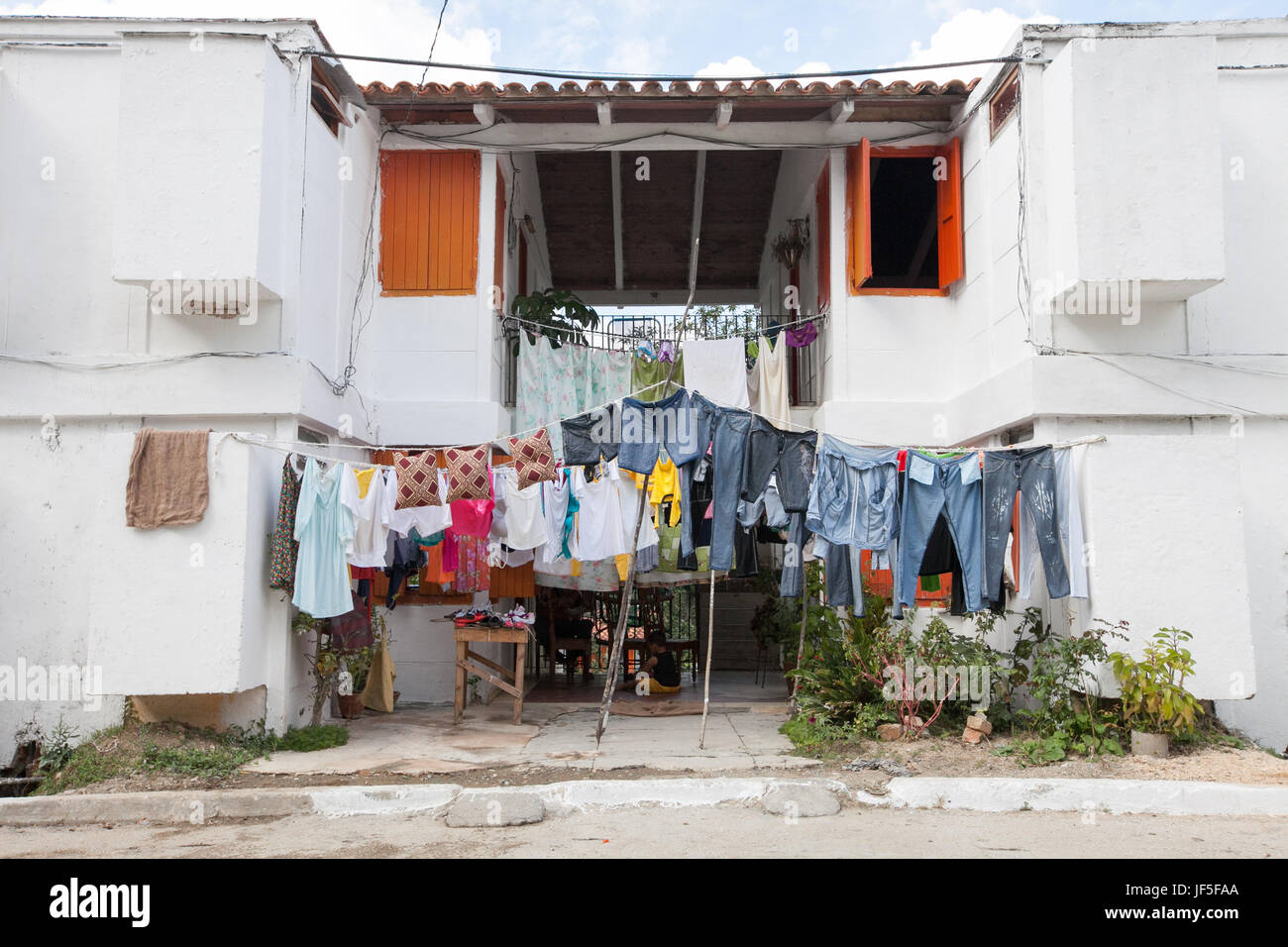 Situato al di fuori dell Avana a una comunità di case per artisti e missioni, servizio lavanderia appeso tra due edifici. Foto Stock