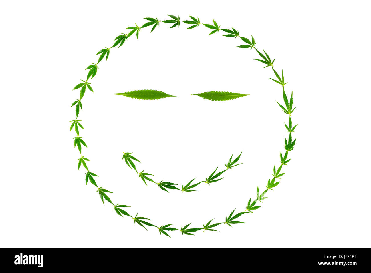 La faccina sorridente con gooks fatta di foglie di canapa Foto Stock