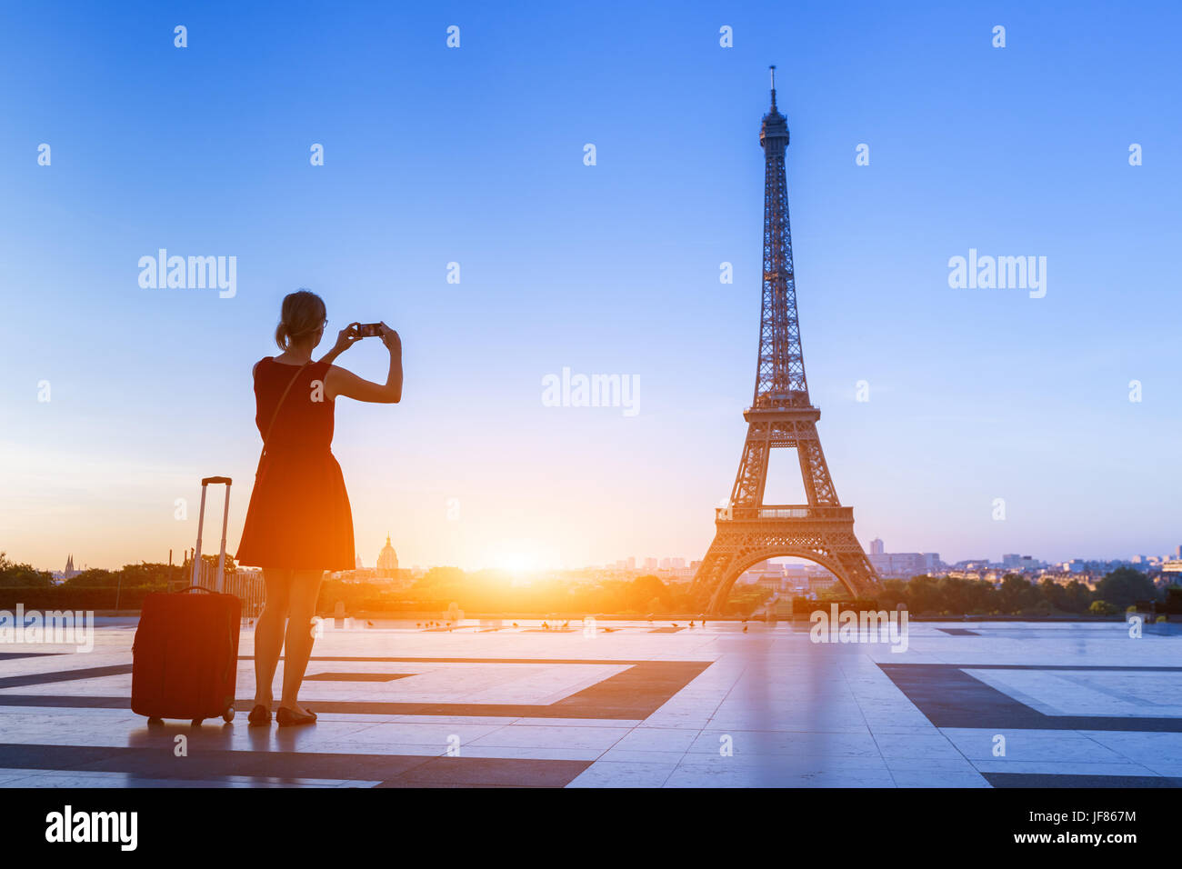 Donna traveler di scattare una foto della Torre Eiffel dal Trocadero con il suo smartphone durante un viaggio di un weekend a Parigi, Francia Foto Stock
