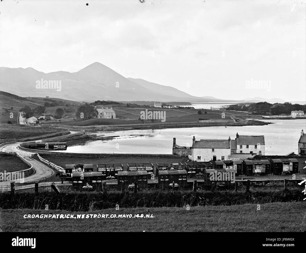Una vista accattivante di Croagh Patrick nella contea di Mayo, in Irlanda, con paesaggi circostanti tra cui Clew Bay e Westport Harbour, catturati in fotografie storiche. Foto Stock Una vista accattivante di Croagh Patrick nella contea di Mayo, in Irlanda, con paesaggi circostanti tra cui Clew Bay e Westport Harbour, catturati in fotografie storiche. Foto Stock