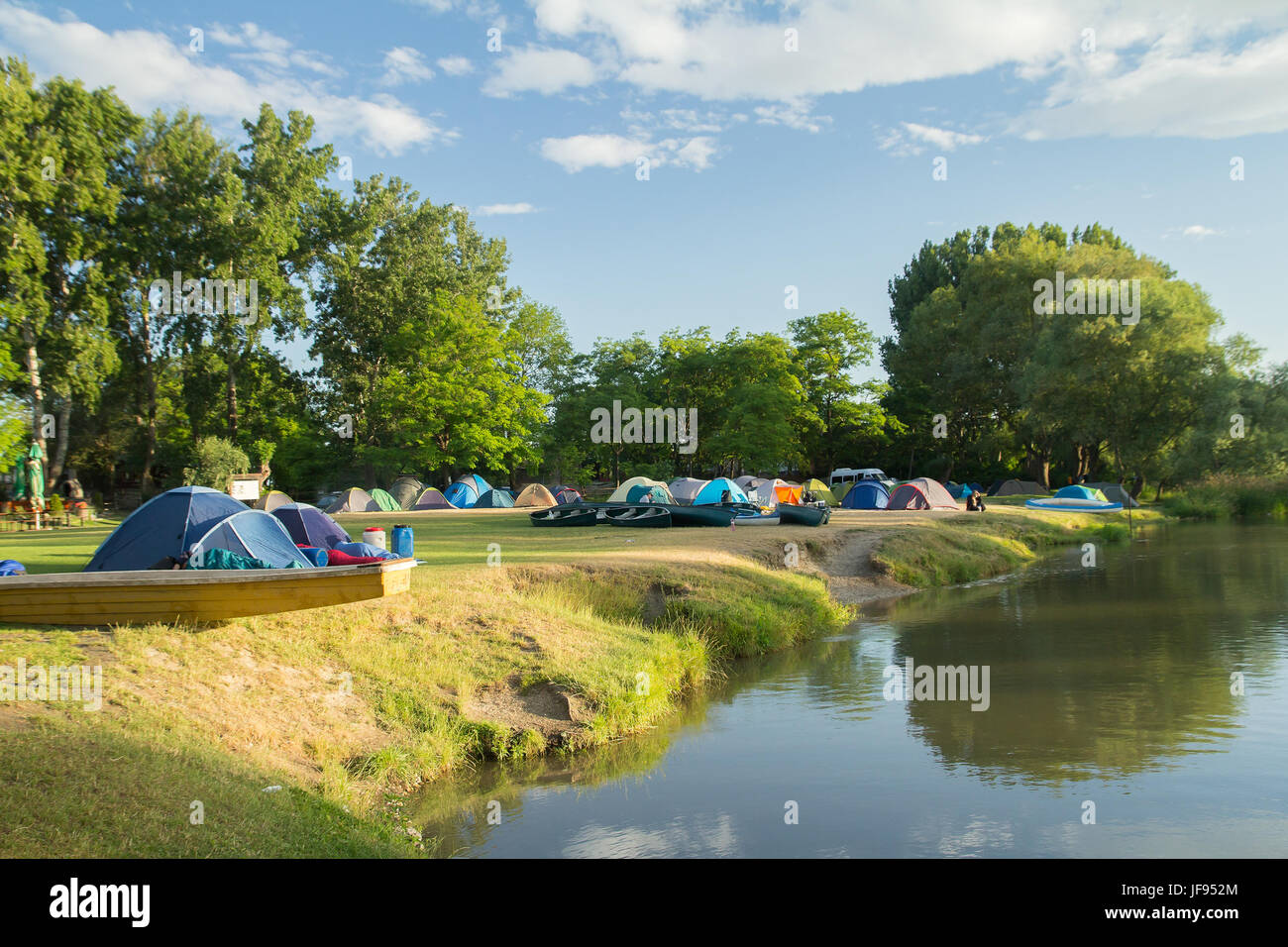 Area campeggio con le tende vicino al fiume Foto Stock