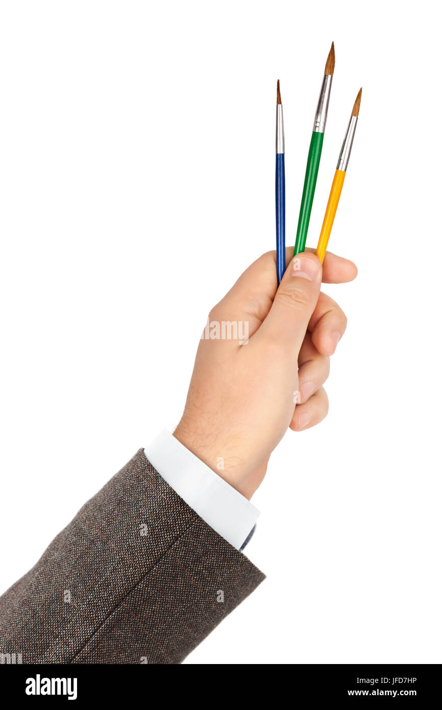 Mano con pennelli multicolore Foto Stock