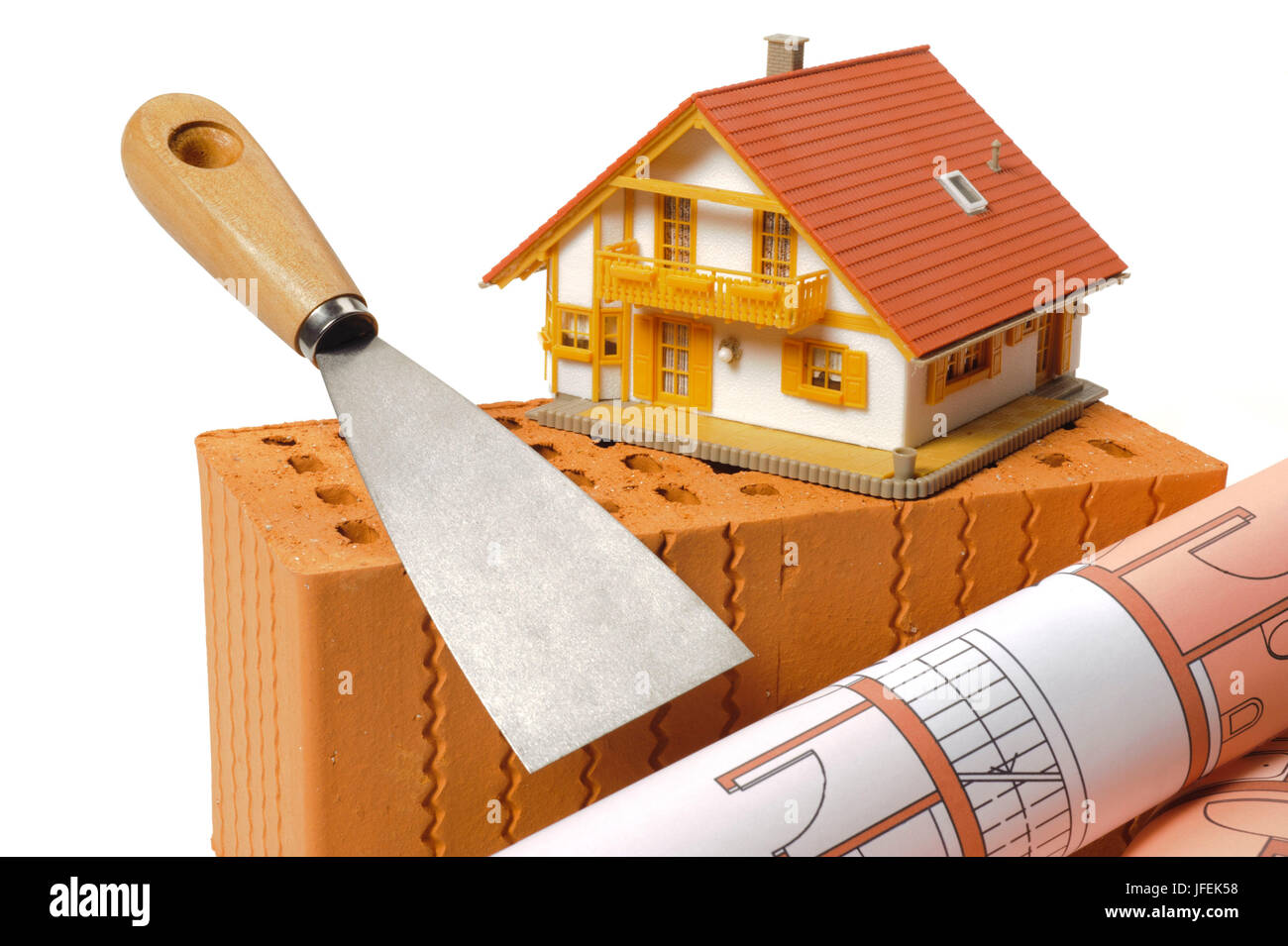 Modello di casa, una spatola e architetto del piano con mattoni rossi, Foto Stock