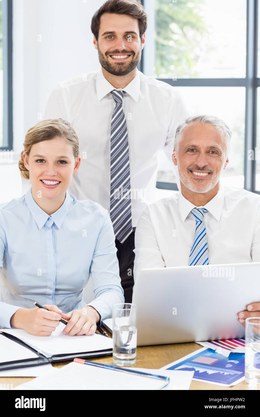 Ritratto di happy business i colleghi a lavorare alla scrivania Foto Stock