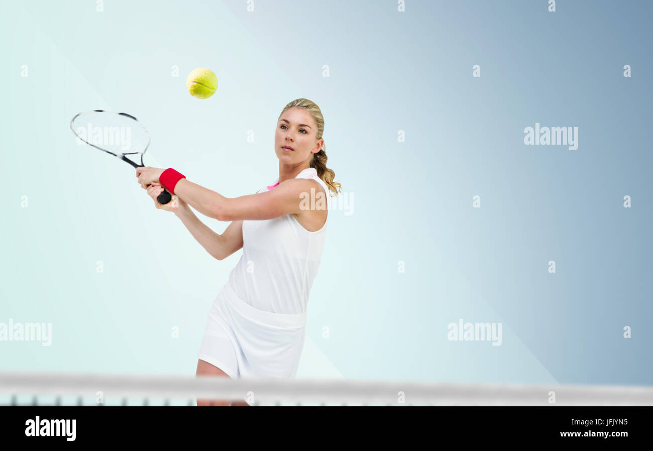 Atleta giocando a tennis con un racket contro colori blu Foto Stock
