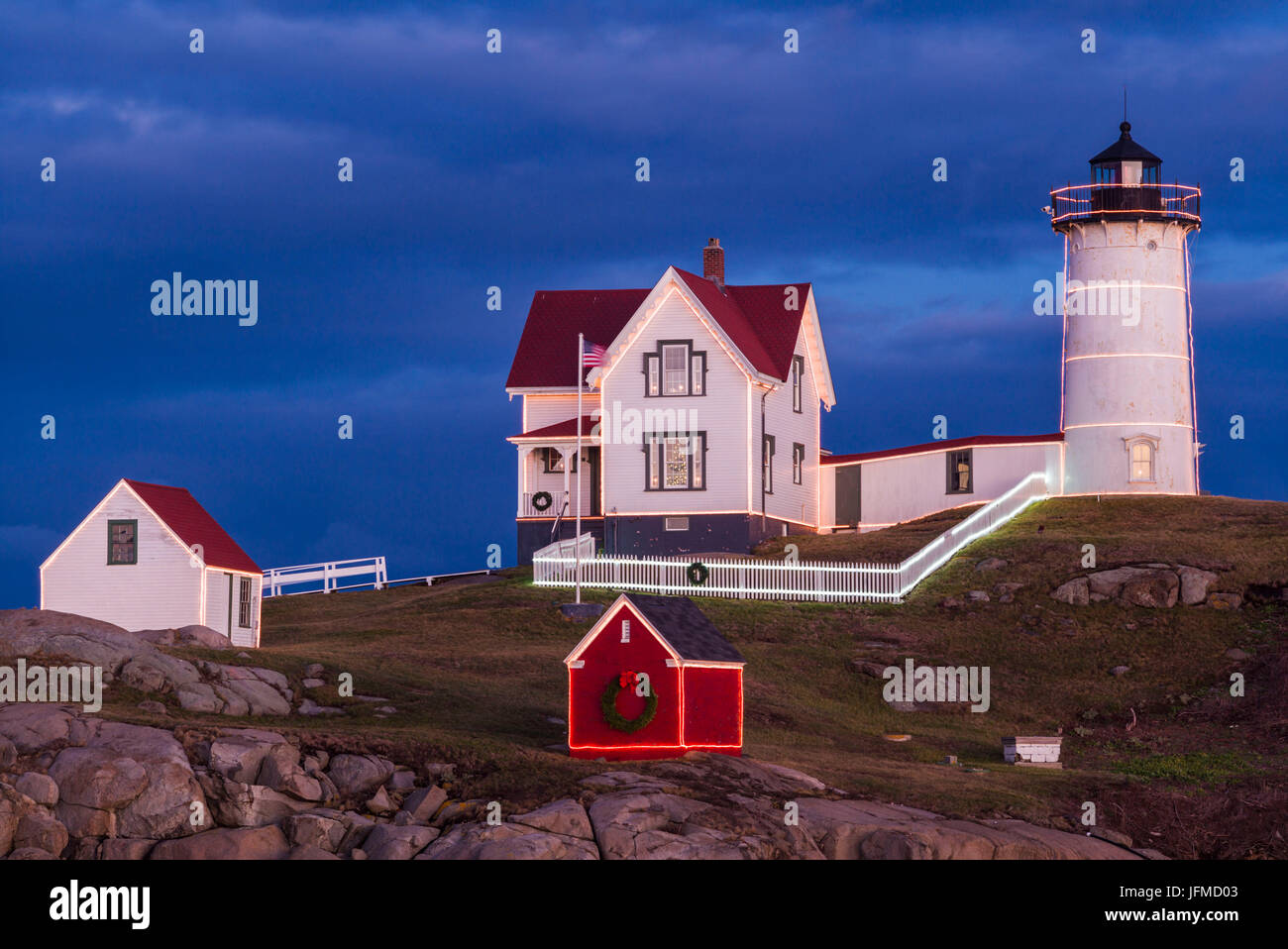 Stati Uniti d'America, Maine, York Beach, Nubble Luce faro con decorazioni di Natale, crepuscolo Foto Stock