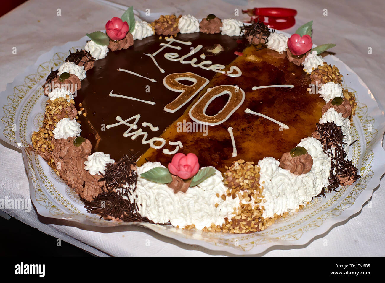 Delizioso sapore due torte di compleanno con un 'felice il novantesimo compleanno' celebrazione come decorazione. Fatta di crema, cioccolato, frutta e mandorle. Foto Stock