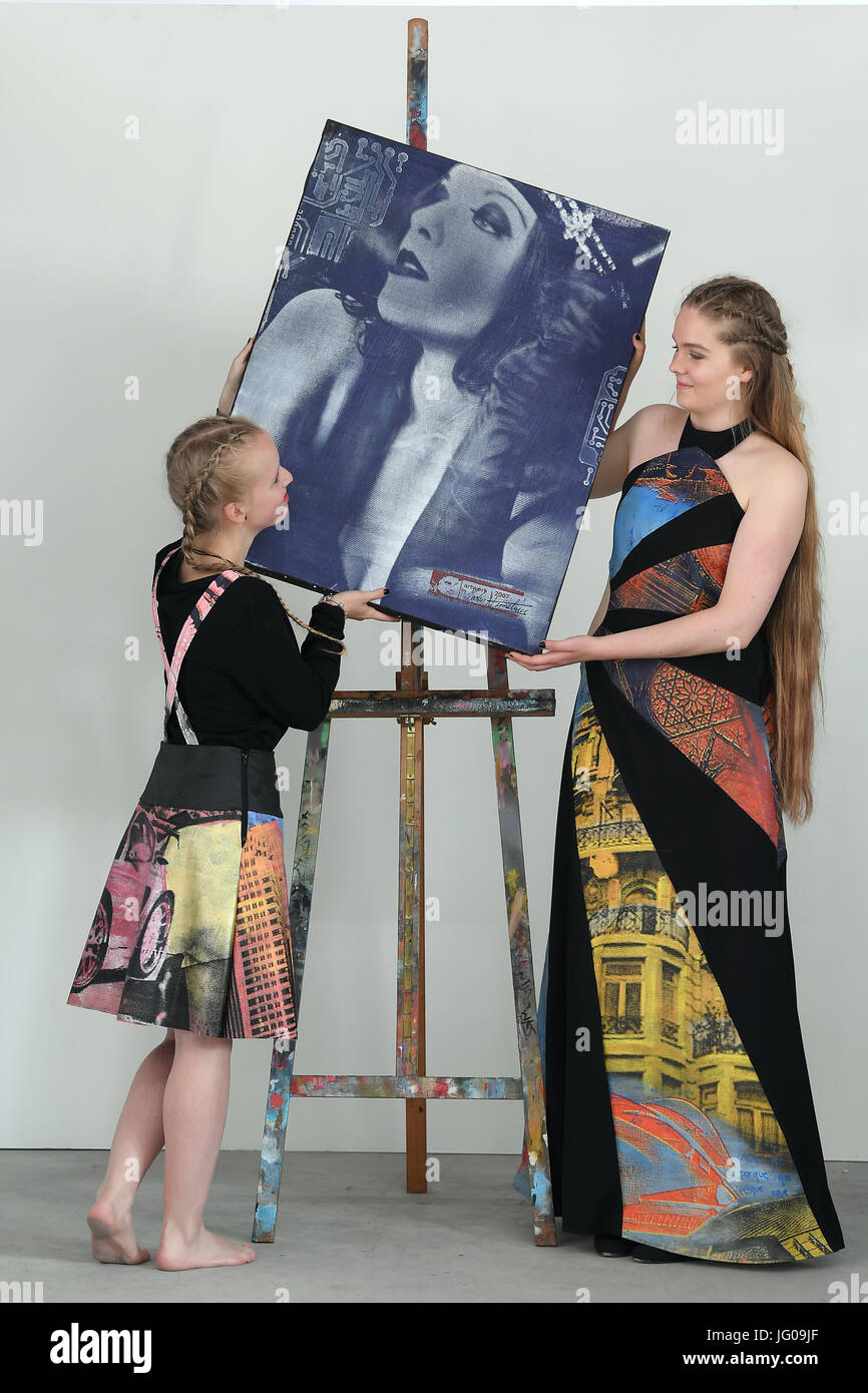 Leipzig, Germania. 3 Luglio, 2017. I modelli Isabel (L) e Charlotte Marie combinare il progettato di abbigliamento di studenti della scuola di moda e design con un dipinto del pittore di Lipsia Martin Hermeling presso la galleria "chreckenberger und Hermeling' a Leipzig, Germania, 3 luglio 2017. La collezione di Magdeburg moda scuola sarà presentato in occasione della Settimana della moda di Berlino sul sesto di luglio. Gli studenti distanti di taglio opera d'arte dell'artista gruppo "chreckenberger und Hermeling' e li ha collocati insieme di nuovo. Foto: Hendrik Schmidt/dpa-Zentralbild/dpa/Alamy Live News Foto Stock