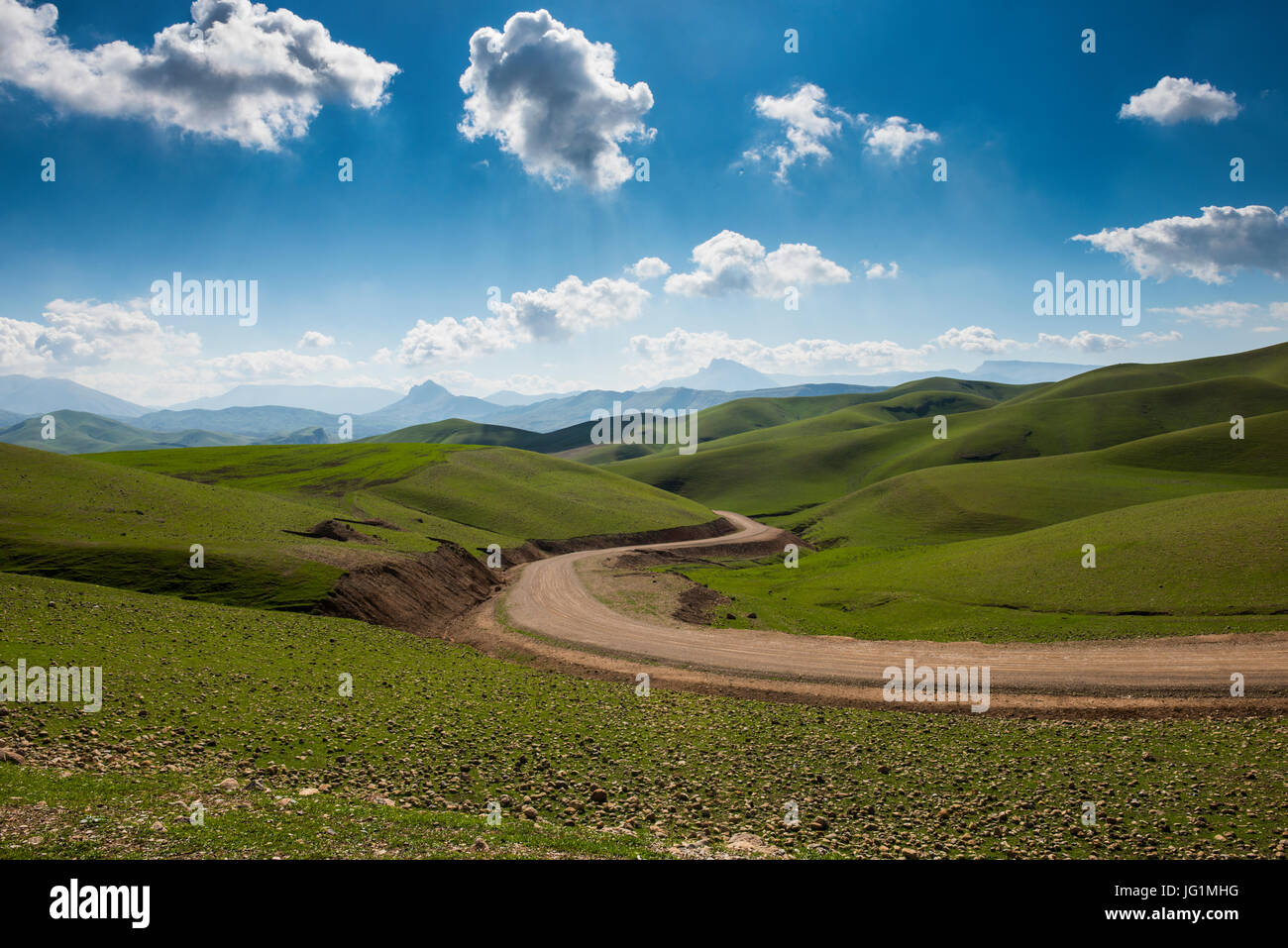 Strada che conduce attraverso il verde paesaggio intorno al Darbandikhan lago artificiale sul confine di Iran, Iraq Kurdistan Foto Stock