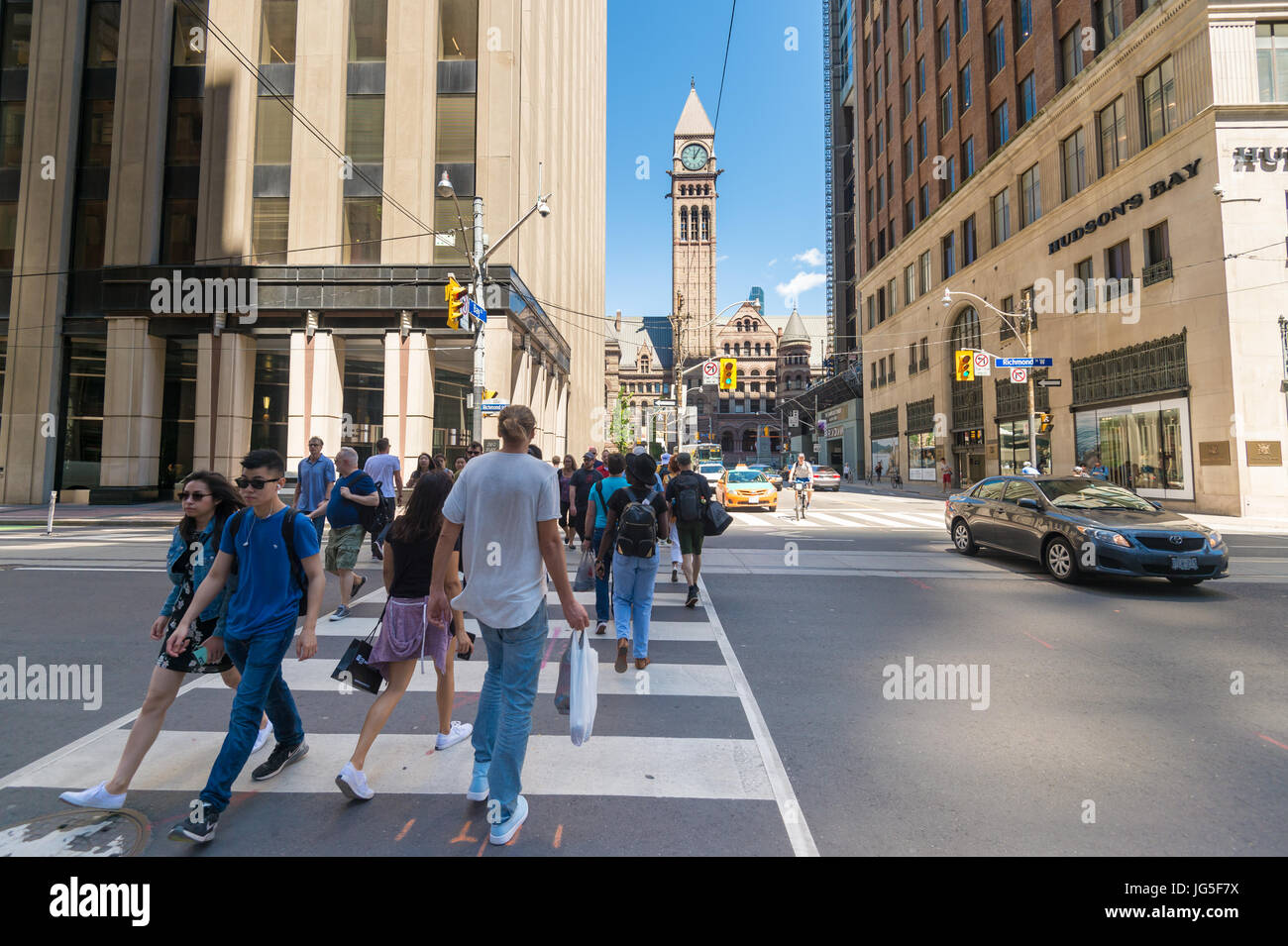 Toronto, CA - 24 Giugno 2017: persone attraversando via su Zebra su Bay Street con il vecchio municipio in background Foto Stock