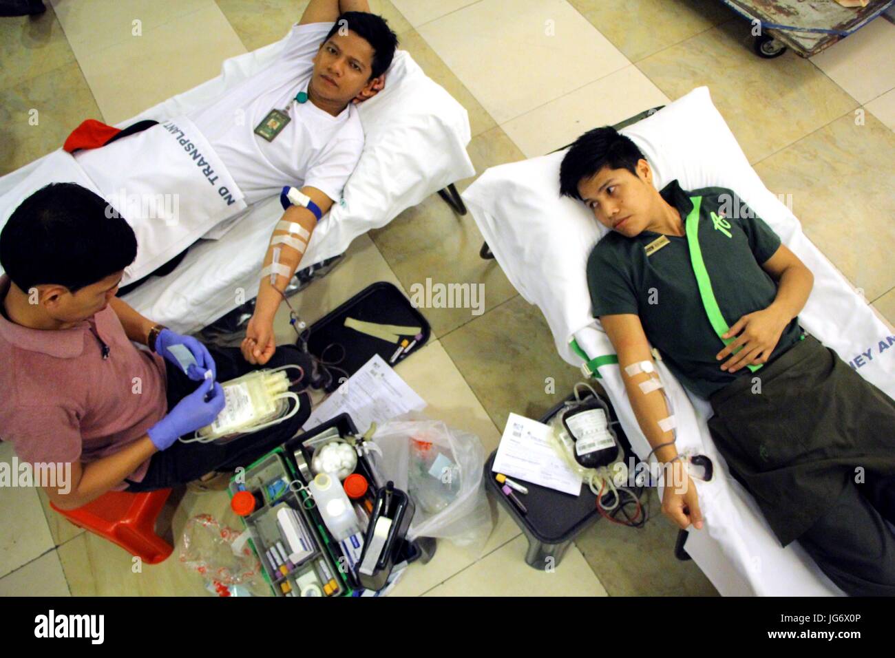 La città di Manila, Filippine. 03 Luglio, 2017. Rene nazionale & Istituto di trapianto (NKTI) Ospedale infermiere Jude Babiano, RN del sangue dipartimento bancario l'estrazione di un sangue dal donatore di sangue durante la loro salasso trimestrale carovana a dipendenti di aristocratico Ristorante nella città di Manila il 3 giugno 2017. Il Dipartimento della Salute (DOH) Chiudere tutti i commerciali banca del sangue a causa della relazione di più il sangue dal commerciale che presumibilmente contaminati dal virus dell AIDS. Credito: Gregorio B. Dantes Jr./Pacific Press/Alamy Live News Foto Stock