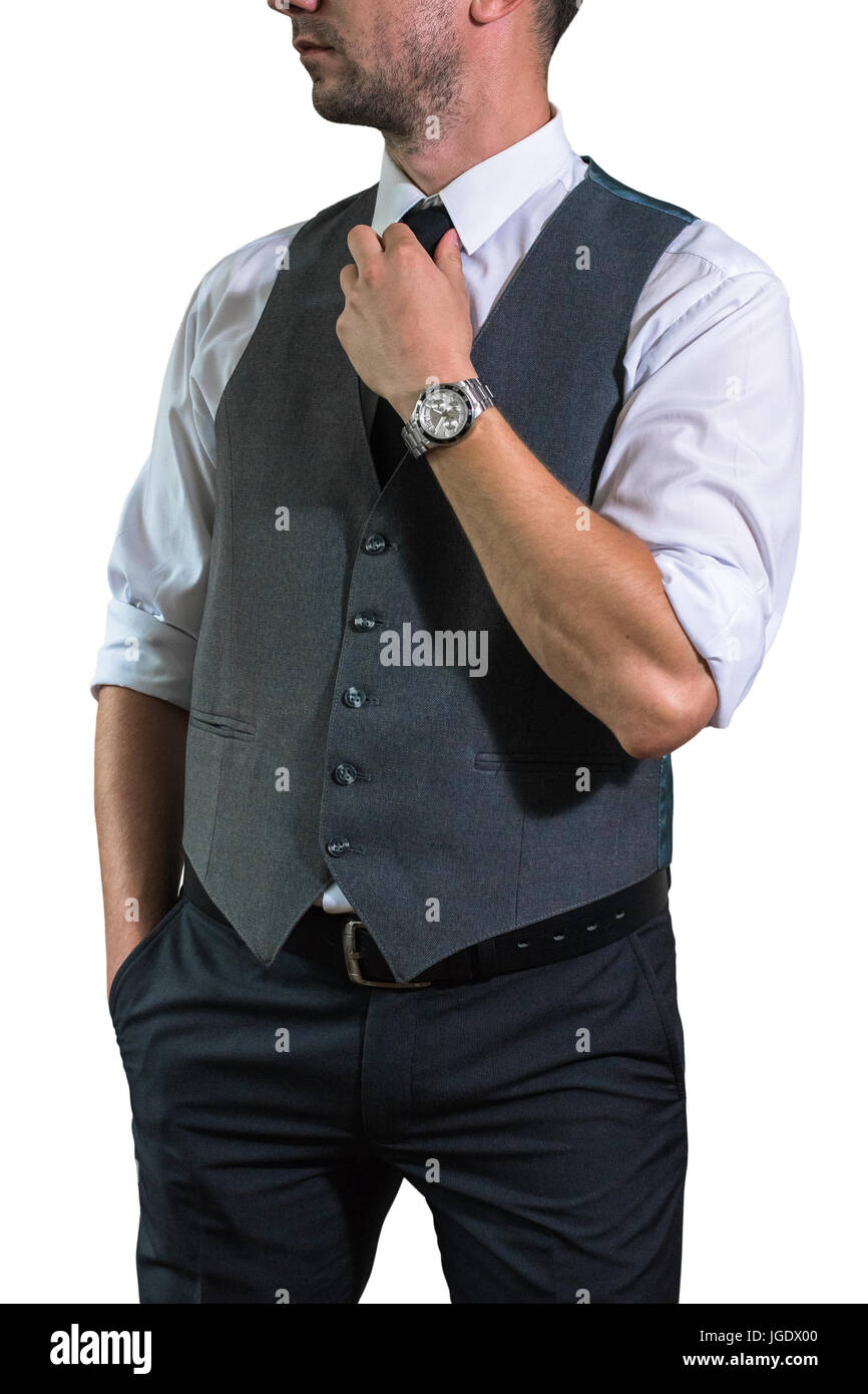 Un giovane imprenditore in una camicia bianca con laminati manica è di raddrizzatura di un black tie. Hopster ragazzo in un elegante GILET grigio Foto Stock