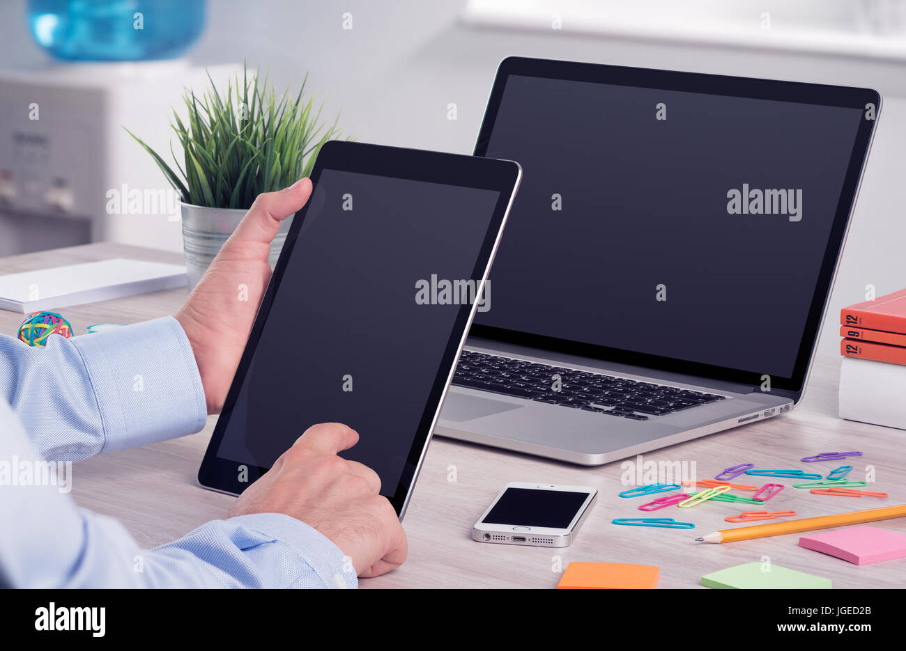 Imprenditore azienda e lavorando con digital tablet pc. Ufficio moderno scrivania sul posto di lavoro con computer portatile mockup e tablet pc mockup in imprenditore h Foto Stock