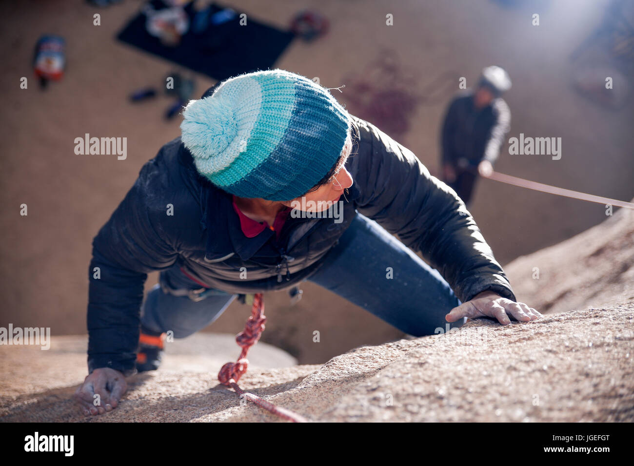 Giovani razza mista donna arrampicata su roccia nel deserto Foto Stock