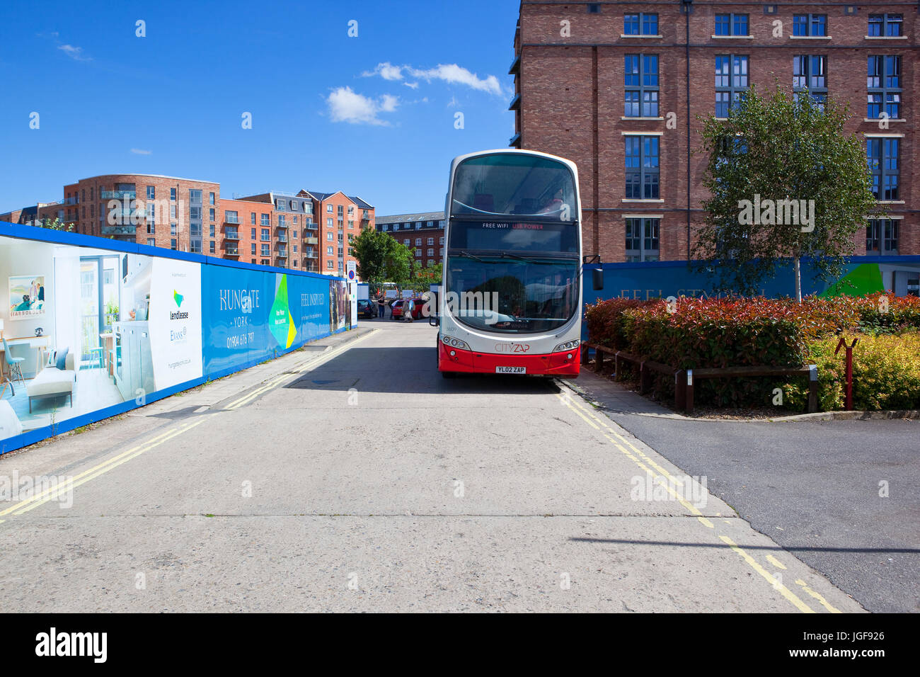 Un bus rosso attende presso il nuovo alloggiamento Hungate sviluppo del sito nella storica città di York Foto Stock