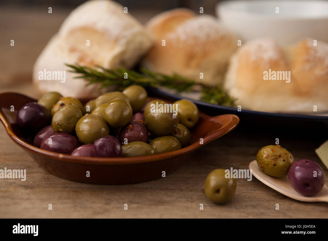 Close up di olive nella piastra da pane sul tavolo Foto Stock