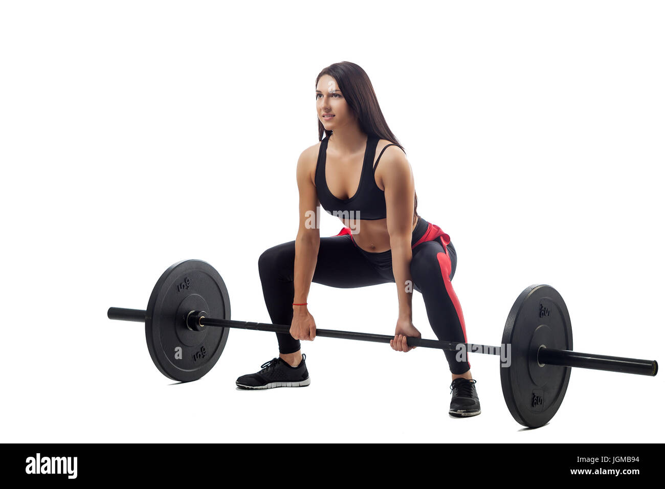 Atletica Giovane donna bruna facendo uno squat con un barbell su un bianco  sfondo isolato, vista laterale, gambe stand ampia, in posizione seduta,  close-up Foto stock - Alamy