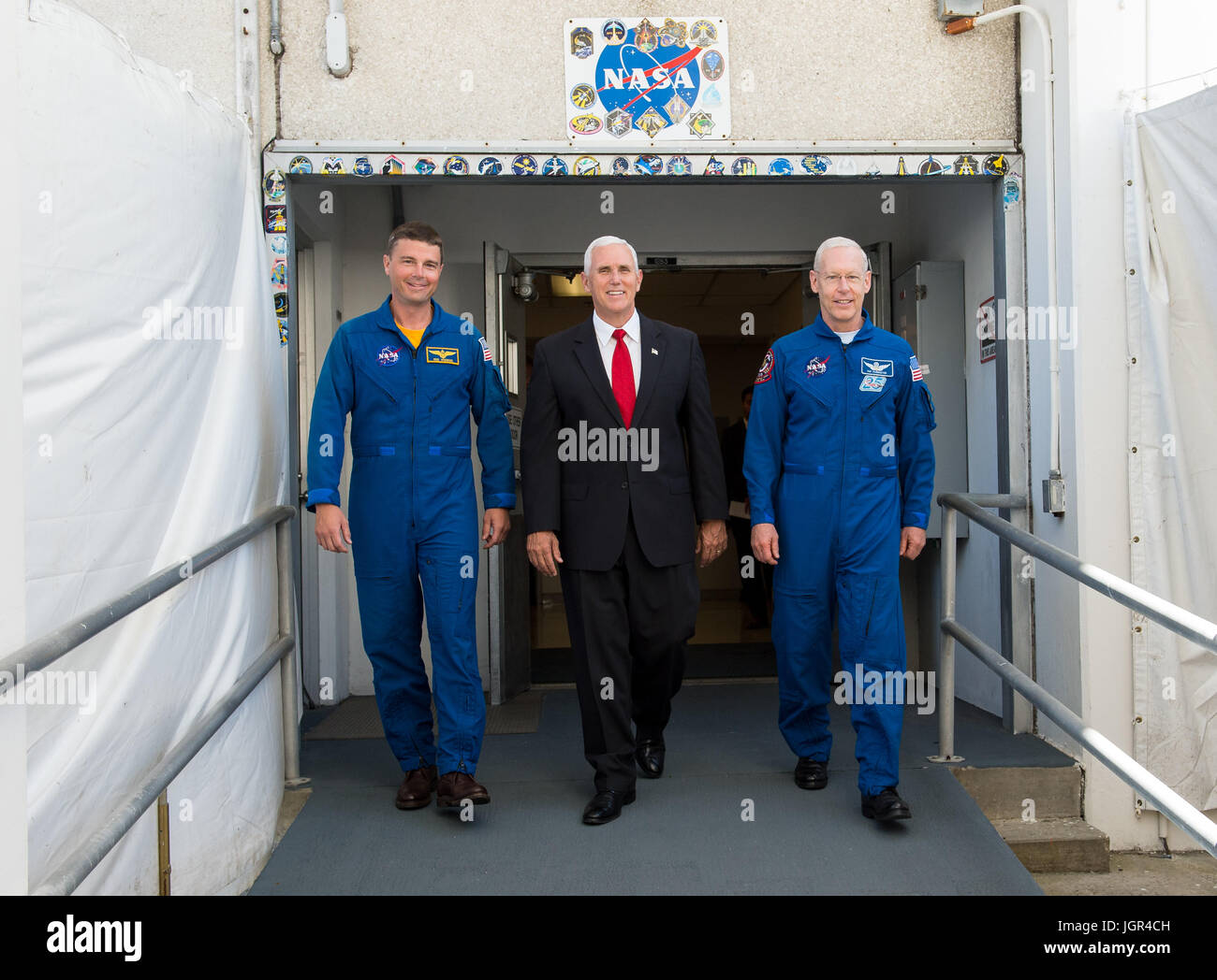 In questa foto rilasciata dalla Nazionale Aeronautica e Spaziale Administration (NASA) Stati Uniti Vice Presidente Mike Pence, centro e astronauta della NASA Reid Wiseman, sinistra e astronauta della NASA Pat Forrester, destra a piedi fuori della storica Porte di equipaggio presso il Kennedy Space Center (KSC) Operazioni e acquista la costruzione di giovedì 6 luglio, 2017, a Cape Canaveral, in Florida. Queste sono le stesse porte che Apollo e lo space shuttle astronauti camminò sulla loro strada per la rampa di lancio. Credito: Aubrey Gemignani/NASA via CNP /MediaPunch Foto Stock