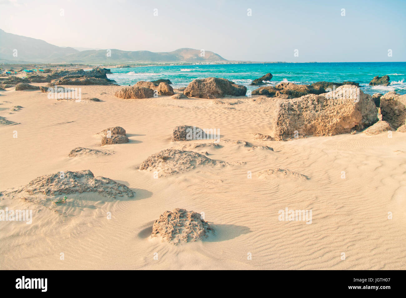 Cross-immagine elaborata di Falasarna rocciosa spiaggia con sabbia ondulata circondato da montagne sulla costa mediterranea, Creta, Grecia Foto Stock