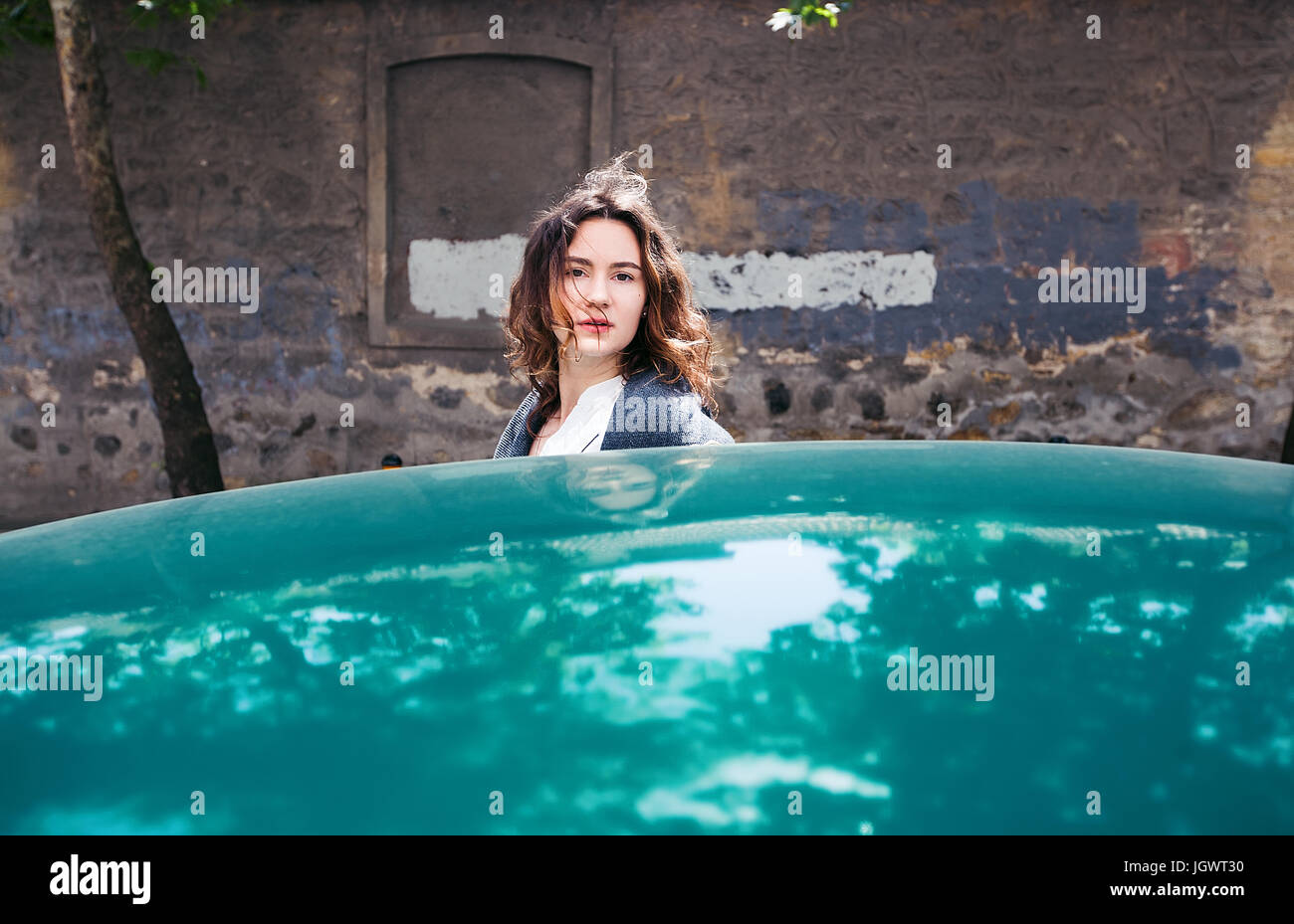 La donna accanto a verde auto Foto Stock