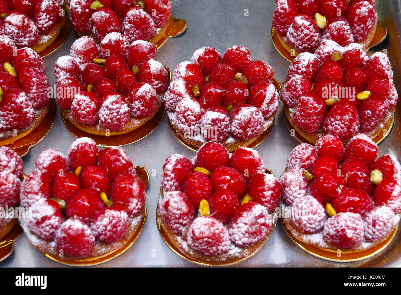 Mini lampone crostate di frutta sul vassoio da forno, visto ad una fiera di strada per celebrare il Giorno della Bastiglia in NYC Foto Stock