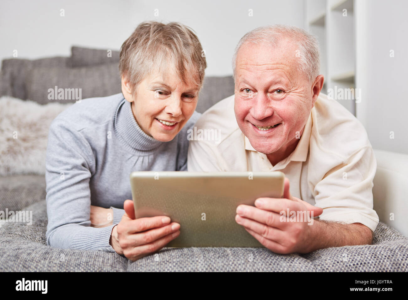 Coppia senior imparare circa il PC tablet con gioia Foto Stock