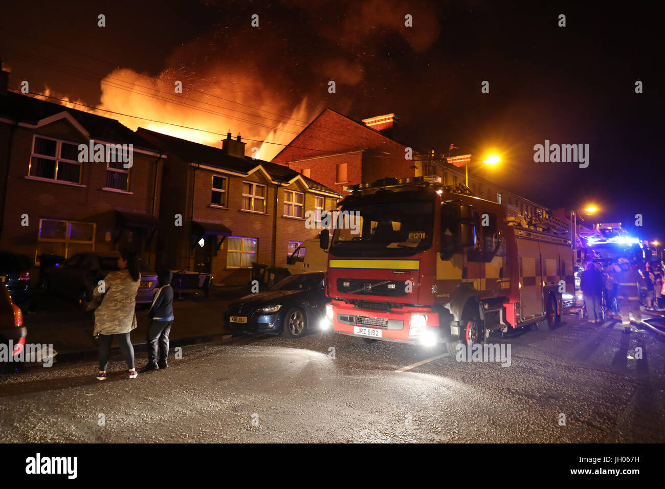 Vigili del fuoco presso la scena come un falò a Ravenscroft Avenue a Belfast è accesa prima della data chiave nella protestante ordine leale marching stagione - il dodicesimo di luglio. Foto Stock