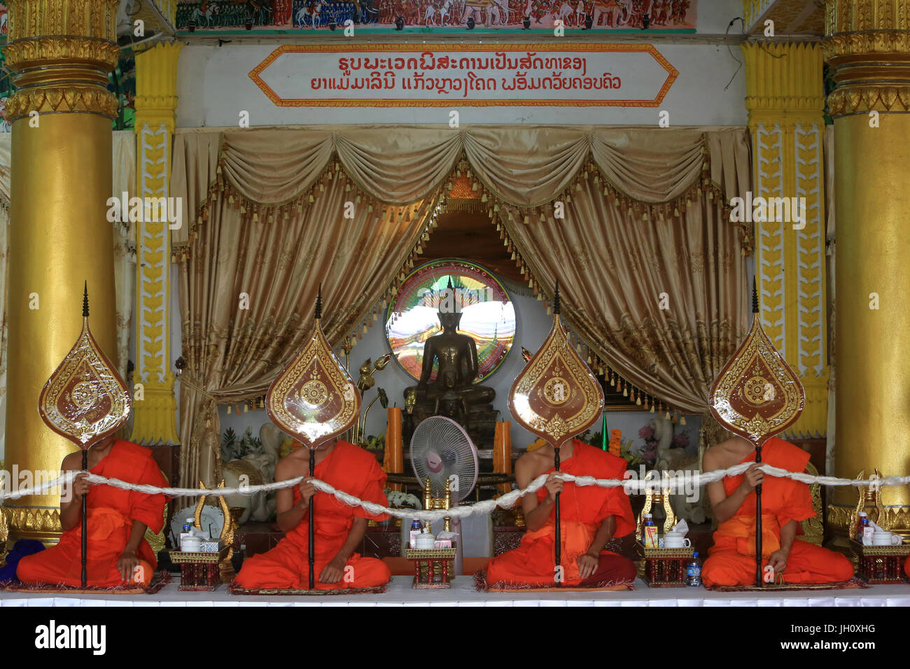 Seduti i monaci buddisti pregano in una cerimonia buddista. Ricordo del defunto. Wat Ongs Teu Mahawihan. Tempio del Buddha di pesanti. Vientiane. Laos. Foto Stock