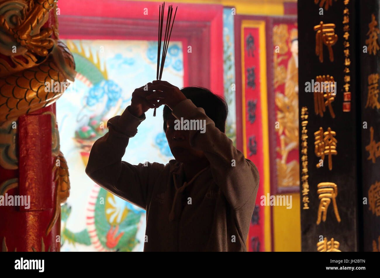 Chua su Lang il tempio taoista. Adoratore buddista. La masterizzazione di bastoncini di incenso. Ho Chi Minh City. Il Vietnam. Foto Stock