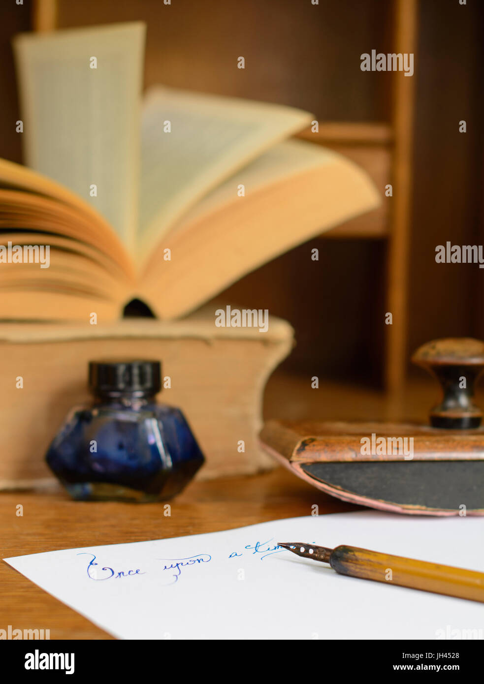 La frase "Una volta" scritto in inchiostro su carta, circondato con un vecchio fermo e libri antichi. Foto Stock