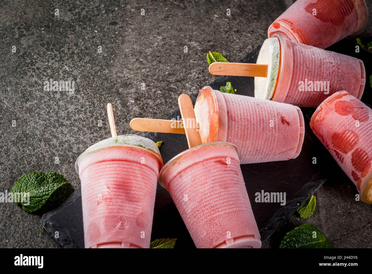 Gelato fatto in casa popsicles. Bevande Surgelati. Cocktail gelato di anguria o berry, menta e calce. Congelati cocktail Margarita con calce. Su nero sto Foto Stock