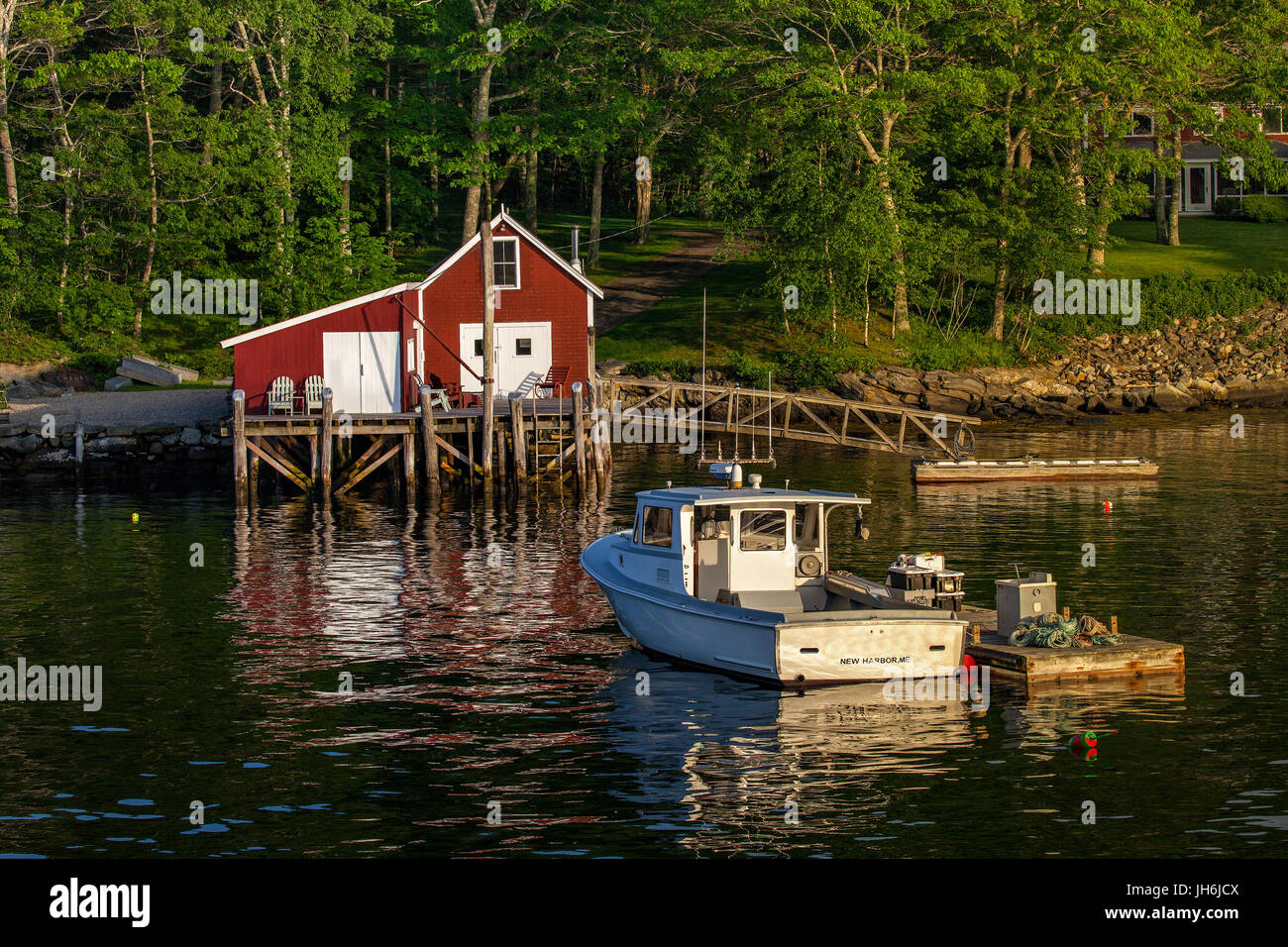 Lobster imbarcazione attraccata ad un molo galleggiante in prossimità di una capanna di aragosta nel nuovo porto, Maine, Stati Uniti d'America. Foto Stock