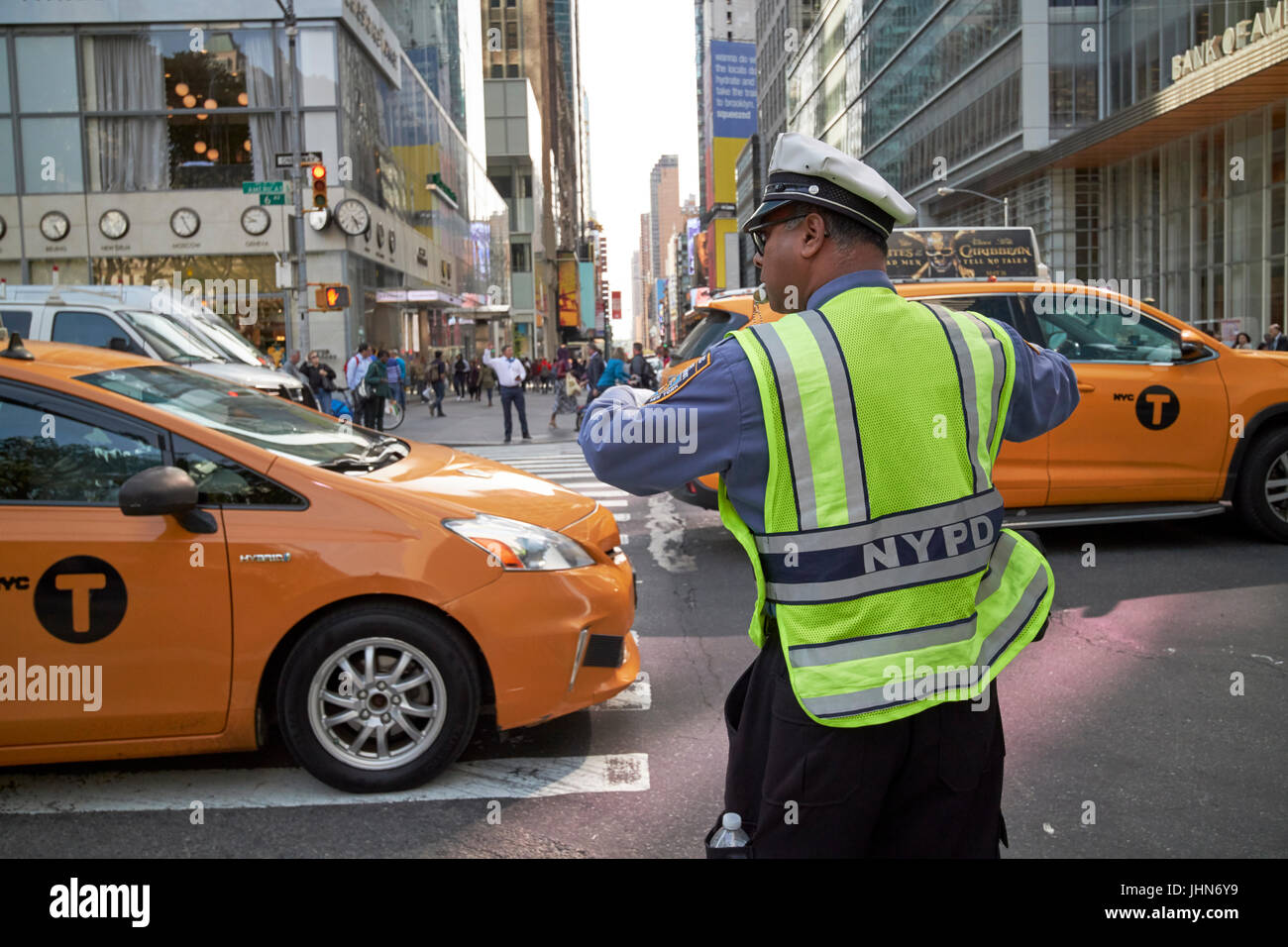 Il traffico di nypd officer con fischietto in bocca dirigere traffico su 6th Ave New York City USA Foto Stock
